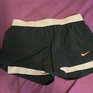 Dark teal Nike running shorts with built in compression shorts